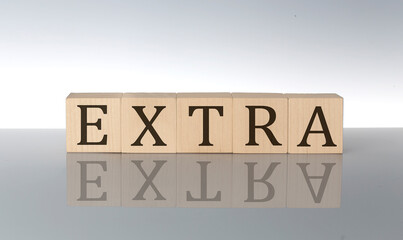 EXTRA word made with building blocks isolated on grey background
