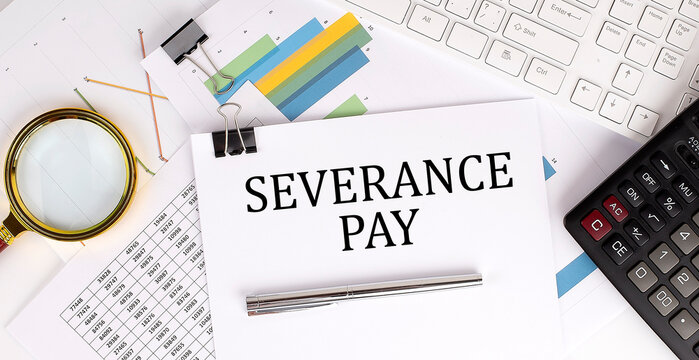 SEVERANCE PAY text on the white paper on the light background with charts paper ,keyboard and calculator