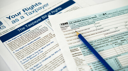 Form 1040 U.S. Individual Income Tax Return with IRS "Your Rights as a Taxpayer" Publication in the background
