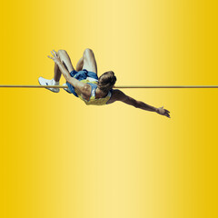 Professional male pole vaulter on background in neon light. Concept of sport, healthy lifestyle,...