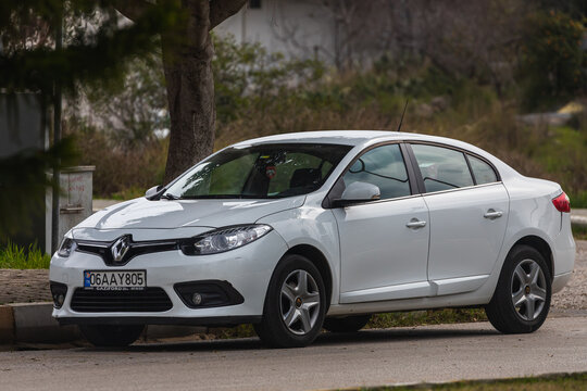 Side, Turkey &ndash; February 20 2022:  swhite Renault Fluence   is parked  on the street on a warm summer day against the backdrop of a street, park