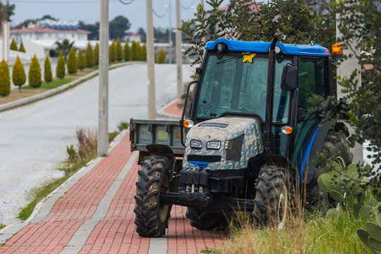 Side; Turkey – February 23 2022 :  blue  Tractor  is parked  on the street on a warm summer day