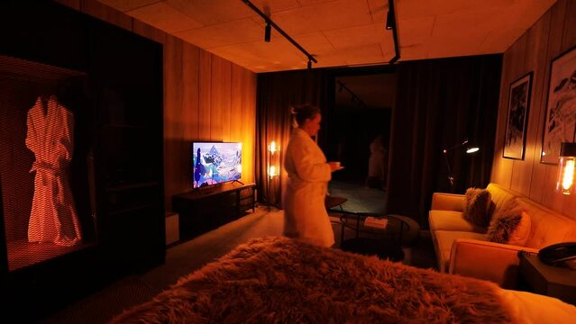 Woman in white bathrobe at cozy hotel vacation