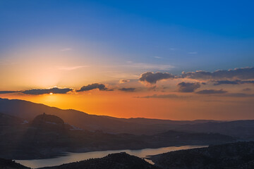 Sunset over the swamp and Zahara de la Sierra, Cadiz. Andalusia. Spain.
