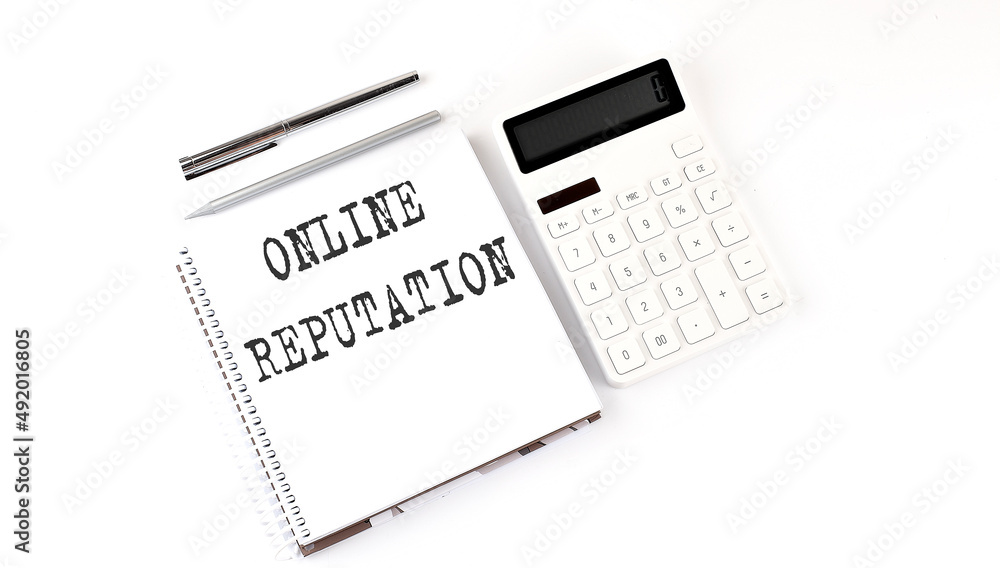 Poster notepad with text online reputation with calculator and pen. white background. business