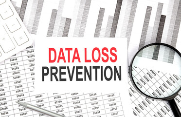 DATA LOSS PREVENTION text on paper with calculator,pen on graph background