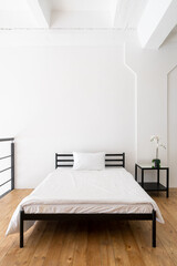 Minimalistic bedroom interior design with wooden floor
