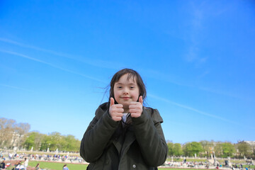 Fototapeta premium Portrait of little girl smiling in Luxembourg Gardens, Paris