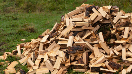 Chopped firewood stacked on a pile. preparation of fuel for heating in winter