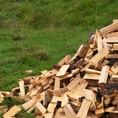 Chopped firewood stacked on a pile. preparation of fuel for heating in winter