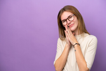 Young English woman isolated on purple background keeps palm together. Person asks for something