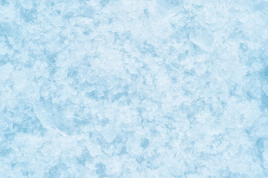 A texture of crumbling ice with soft shadows. The concept of the background of freezing products. Background. Top view. Flat lay