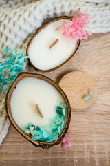 Fototapeta na wymiar original handmade candle in coconut. natural soy wax candle