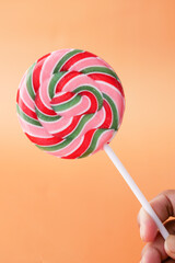 close up of lollipop candy on orange background 