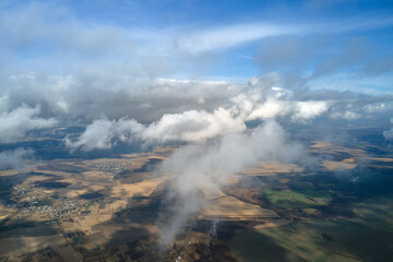 Aerial view from high altitude of earth covered with puffy rainy clouds forming before rainstorm
