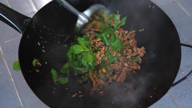 Holy basil minced pork stir fry. Pad Gaprao is one of the most favorite thai food. Holy basil stir fry in 4K.