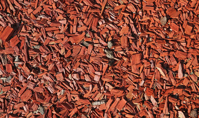 Full frame closeup of brown red bark mulch for cover of garden bed