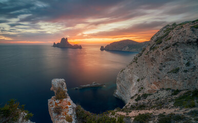 Fototapeta na wymiar Sunset over the sea , Cap Llentrisca with es vedra island , Ibiza