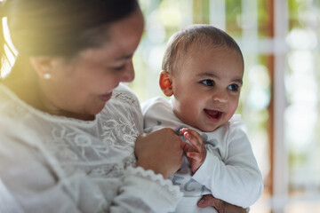 Mommys lil love bug. Shot of an adorable baby boy bonding with his mother at home.
