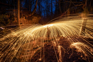 Burning steel wool spinned. Showers of glowing sparks from spinning steel wool