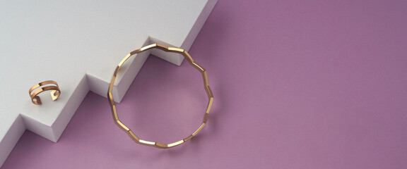 Panorama of Zig zag shape bracelet and golden ring on white geometric podium on pink background with copy space