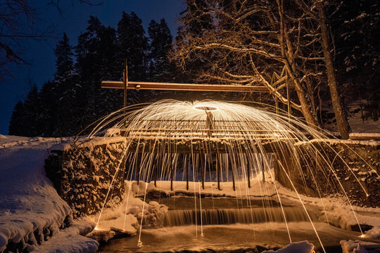 Burning steel wool spinned. Showers of glowing sparks from spinning steel wool - Powered by Adobe