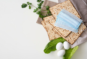Banner. Layout of  Traditional Matzo prepared for Passover with egg, medical mask for corona, green...