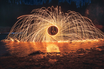 Burning steel wool spinned. Showers of glowing sparks from spinning steel wool