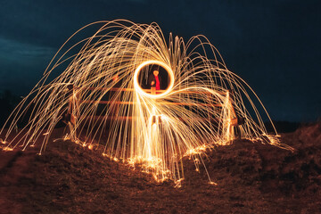 Burning steel wool spinned. Showers of glowing sparks from spinning steel wool