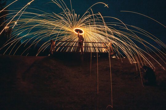 Burning steel wool spinned. Showers of glowing sparks from spinning steel wool