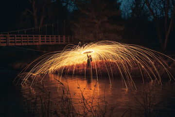 Burning steel wool spinned. Showers of glowing sparks from spinning steel wool