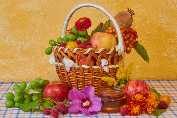 fruit basket on the table,assorted fresh fruits on a yellow wall background