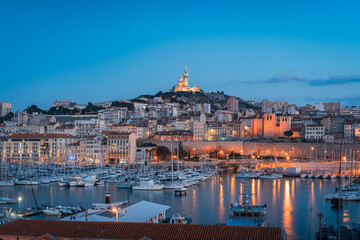 Fototapeta na wymiar The Old Port and Basilica of Notre Dame de la Garde at dusk in Marseille, France