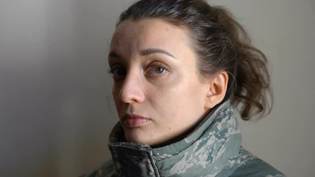 Indoor portrait of young girl wearing military uniform, mandatory conscription in Ukraine, Russian invasion, war concepts