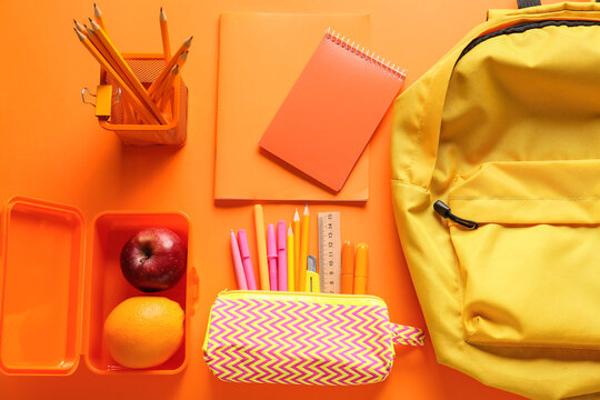 Set of stationery with fruits on color background