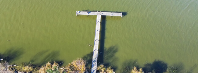 Panoramic aerial view fishing dock jetty with fishermen anglers on White Rock Lake near Dallas...