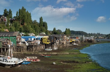 Fototapeta na wymiar Fascinatinhg stilt houses (palafitos) on the fjord shores of the city of Castro, Chiloe Island, Chile