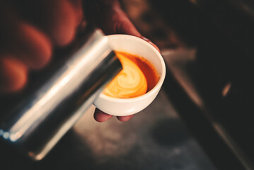 Barista man hand making cappuccino Coffee with espresso and milk in cafe