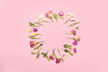 Fototapeta premium Frame made of blooming flowers on color background