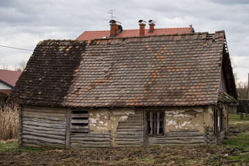 Fototapeta na wymiar Sunja, Croatia, April 20,2021 :Abandoned traditional old wooden house. 