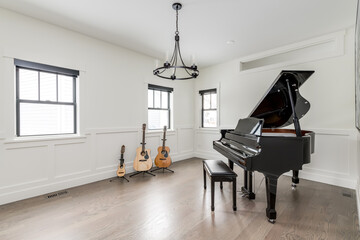 Styled Interior of Music Room. Empty room with grand piano, guitars and ukulele. Private music lesson room.
