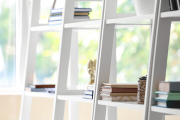 White book shelves in modern room, closeup