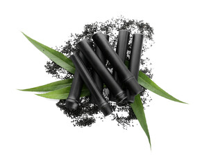 Black bamboo sticks and activated carbon powder isolated on white background
