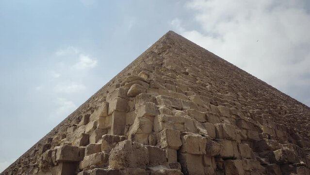 The Great Pyramid of Giza against blue sky. Cairo, Egypt. Traveling, world wonder and historic concept. Closeup