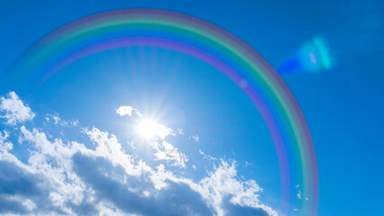 Bright blue sky with rainbow and sunshine_wide_04