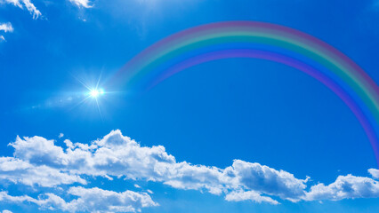 Bright blue sky with rainbow and sunshine_wide_17