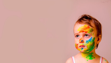 Portrait of beautiful young child girl with children's face makeup. Copy space. Horizontal image.