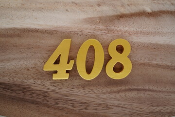 Golden Arabic numerals on a real brown and white wooden floor number 408