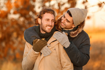 Portrait of happy gay couple in autumn park