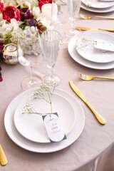 Stylish table setting with wedding invitations and gypsophila flowers